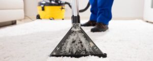 Professional carpet cleaning in Atlanta by Clean Obsession, showcasing deep-cleaning equipment removing dirt and stains from a residential carpet.