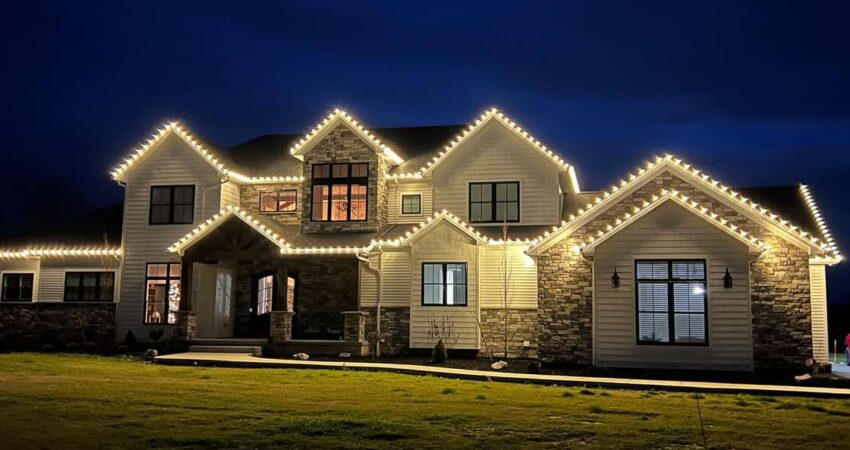 Beautiful Sarasota home adorned with residential holiday lighting, featuring roofline and pathway illumination.