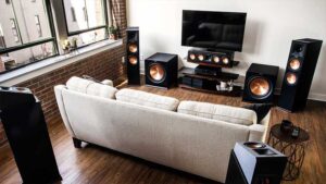 A professional home theater setup with a projector, surround sound system, and wall-mounted TV in an Atlanta living room.