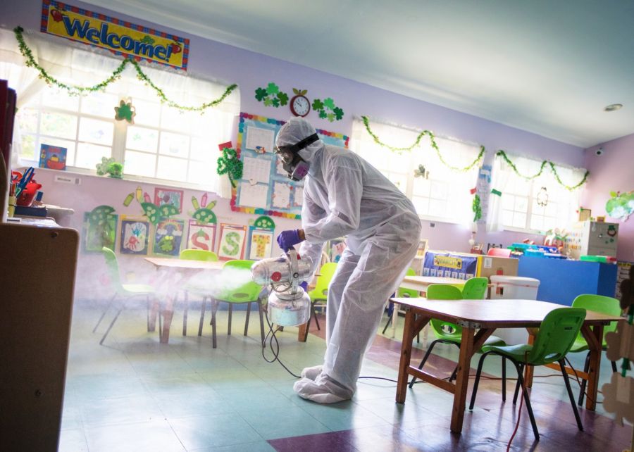 A professional technician using eco-friendly tools to remove odors from a Sarasota home.